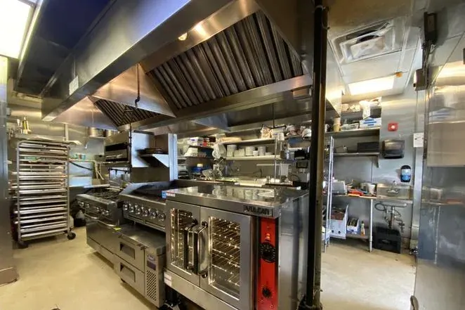 Commercial cooking equipment in a professional kitchen serviced by S&S Equipment